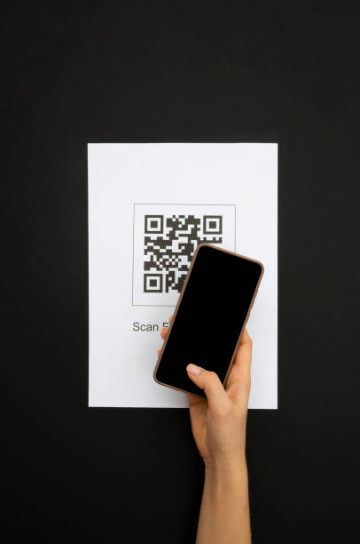 istock Top view Hand's customer scan QR code for online menu service at table in restaurant. New contactless technology lifestyle protection coronavirus pandemic in restaurant. 1374786809