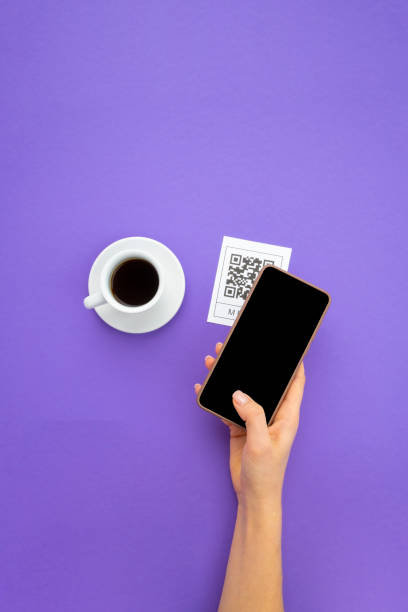 Top view Hand's customer scan QR code for online menu service at table in restaurant. New contactless technology lifestyle protection coronavirus pandemic in restaurant.
