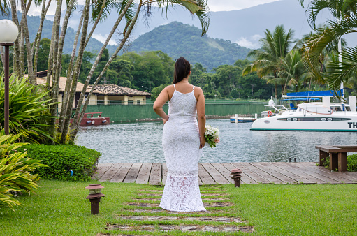 Bride in wedding dress in a beautiful location by the sea