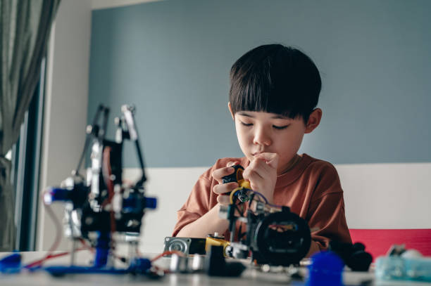istock Asian boy building robot toy for school science project 1374802369