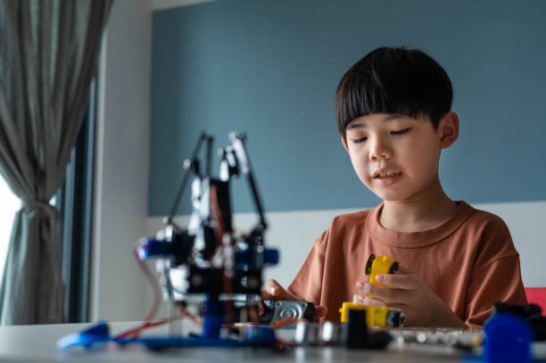 istock Asian boy building robot toy for school science project 1374805582
