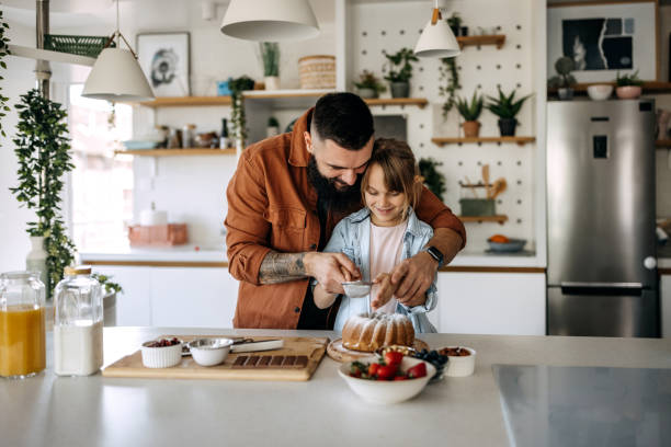 istock Father and cute little daughter making sponge cake 1374809270