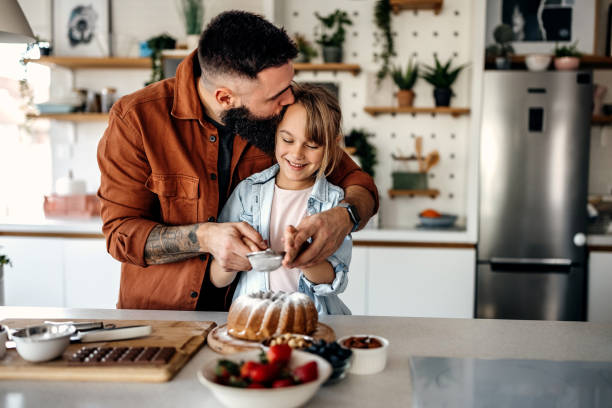 istock Father and daughter preparing cake together 1374810304