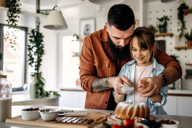 istock Father and cute little daughter making sponge cake 1374810309