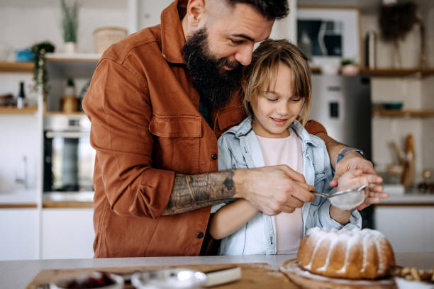 istock Father and daughter preparing cake together 1374811381