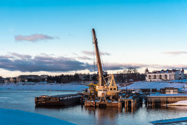 Floating cranes on a frozen river in winter.