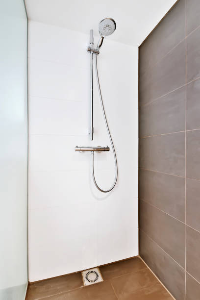 istock Shower cabin in a minimalist style with a brown tiled wall 1374833408