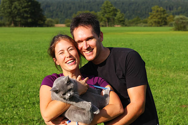 istock Young loving couple with their cat posing in nature 137484419