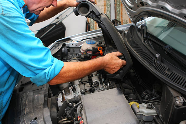 istock In auto repair shop....Car mechanic is fixing engine 137484521