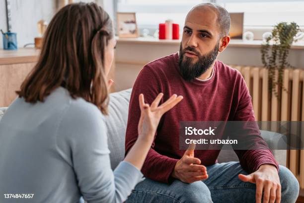 Young Couple Arguing At Home Stock Photo - Download Image Now - Couple - Relationship, Discussion, Talking