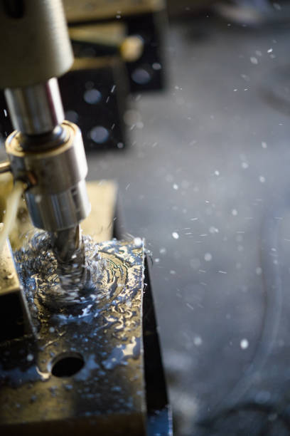 istock Metal Drill Press close-up with lubricant splashing 1374855431