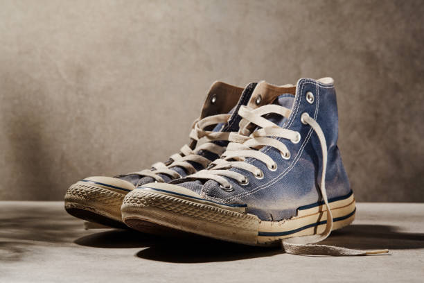 istock Pair of old wornout canvas shoes 1374855446