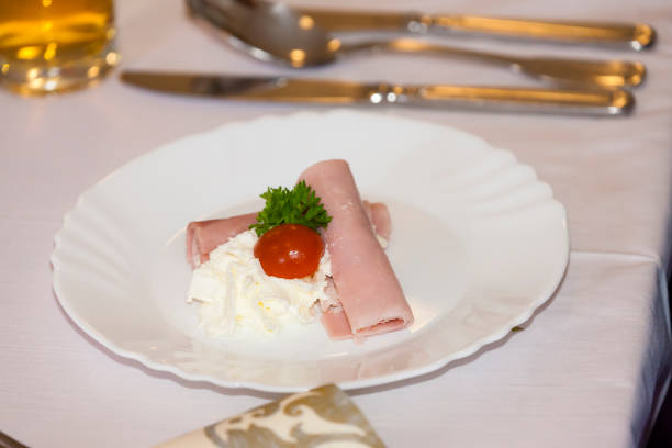 ham roll filled with horseradich spread as a starter  on wedding table