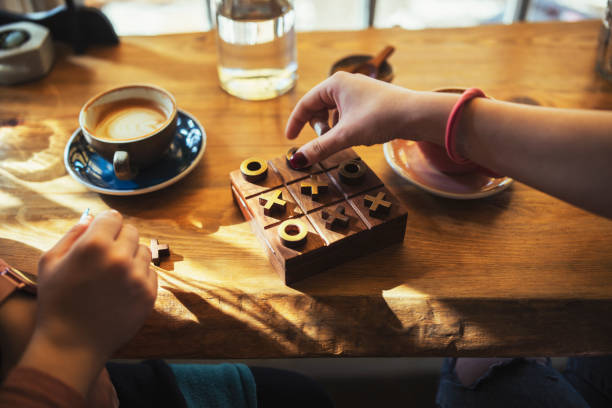 Close up of unrecognizable women playing board game.