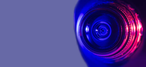 istock Camera lens with purple and pink backlight. Cyberpunk style. Banner 1374877937