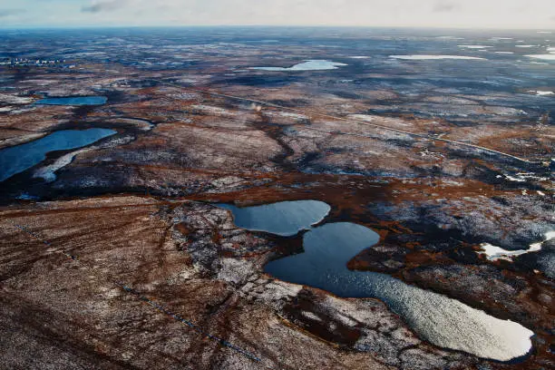 Aerial view and top view of the Lake in the tundra on the Taimyr Peninsula in Russia. Beautiful natural background. Blurred image, selective focus.