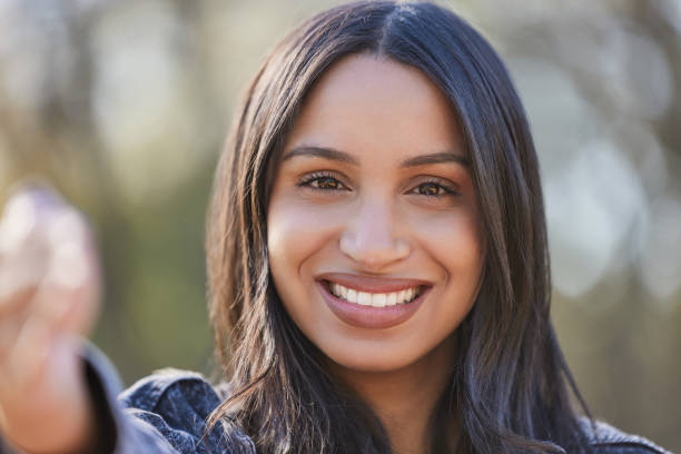 istock Shot of a beautiful young student using her phone while sitting outside 1374886737