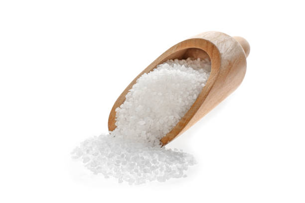 istock Wooden scoop with salt isolated on white 1374892587