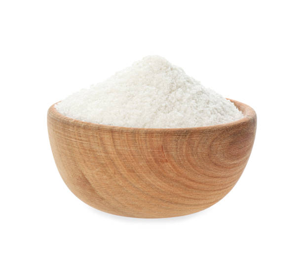 istock Wooden bowl with natural salt isolated on white 1374893630