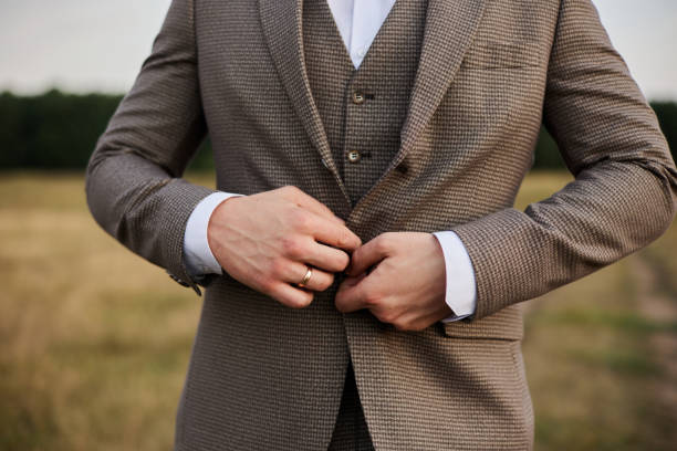 istock The stylish groom adjusts an elegant jacket on himself 1374895195