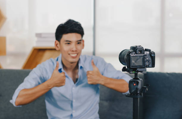 istock A young attractive Asian man is recoding footage for online contents. 1374905826