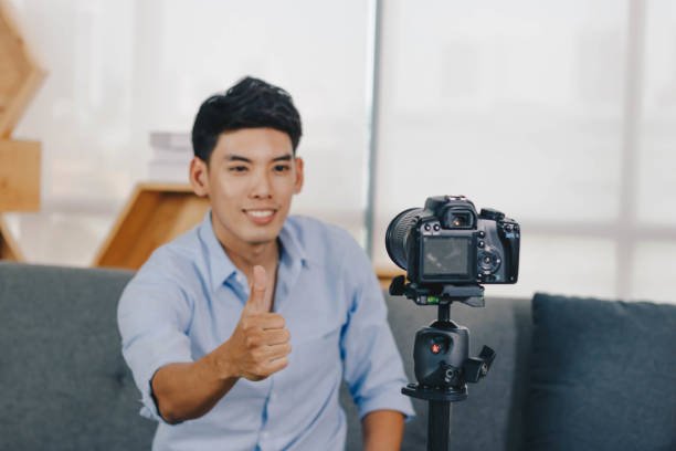 istock A young attractive Asian man is recoding footage for online contents. 1374906346