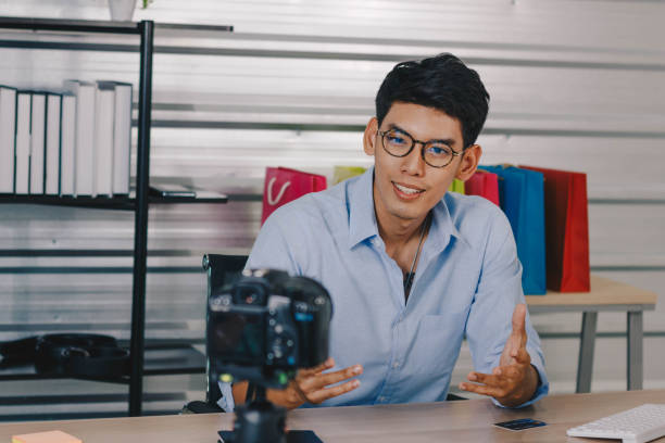 istock A young attractive Asian man is recoding footage for online contents. 1374906352