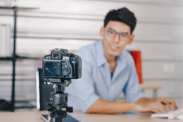 istock A young attractive Asian man is recoding footage for online contents. 1374912461