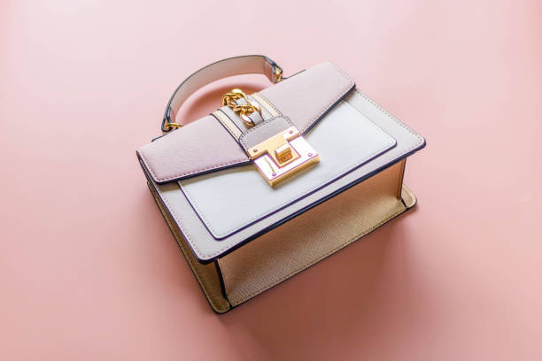 istock Luxury pink tone handbag on a light pink background. 1374912967