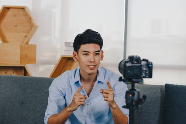 istock A young attractive Asian man is recoding footage for online contents. 1374912976