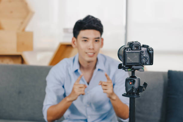 istock A young attractive Asian man is recoding footage for online contents. 1374913495
