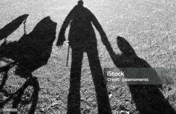 Shadows Of Person Holding Hands With A Baby And A Stroller Stock Photo - Download Image Now