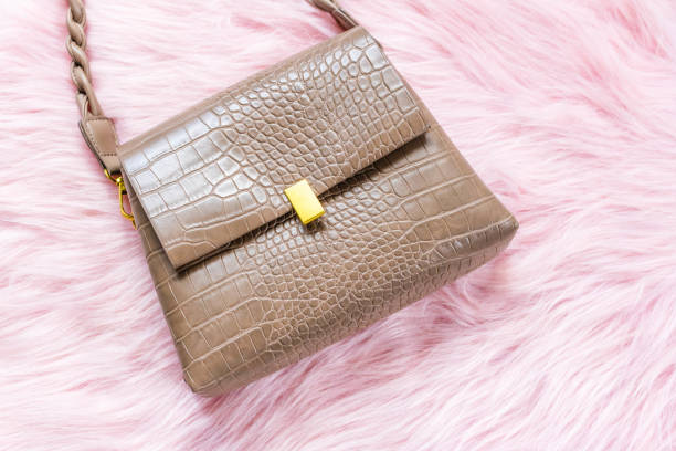 istock Luxury brown handbag on a light pink background. 1374917806