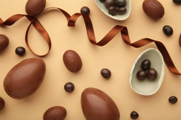 istock Easter composition with chocolate eggs and brown ribbon on beige background 1374935508