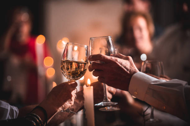 celebratory toast cheers wine glasses between friends at candle light social event party - political party concepts glamour friendship imagens e fotografias de stock