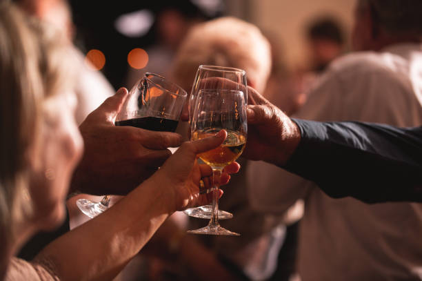 celebratory toast wine glasses between friends at candle light social event party - political party concepts glamour friendship imagens e fotografias de stock