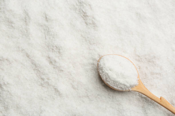 istock Natural salt and wooden spoon, top view. Space for text 1374942333