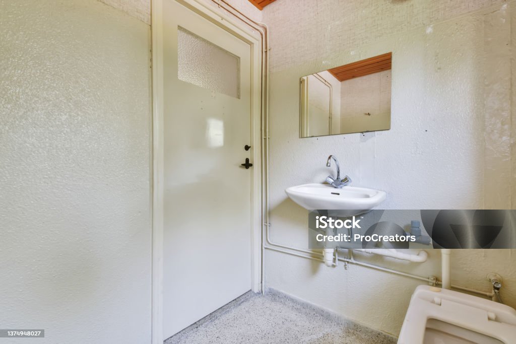 Delightful bathroom with sink Delightful bathroom with sink and square toilet Apartment Stock Photo