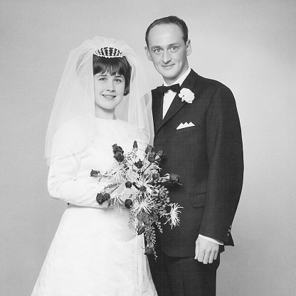 Vintage portrait of a caucasian couple on their wedding day back in 1966. 