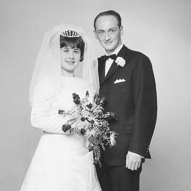 Black and white photo of couple at their wedding day Vintage portrait of a caucasian couple on their wedding day back in 1966.  wedding photos stock pictures, royalty-free photos & images