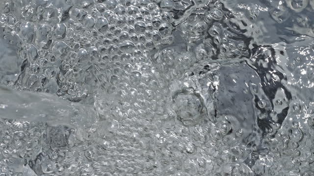 Water stream directly above at slow motion.