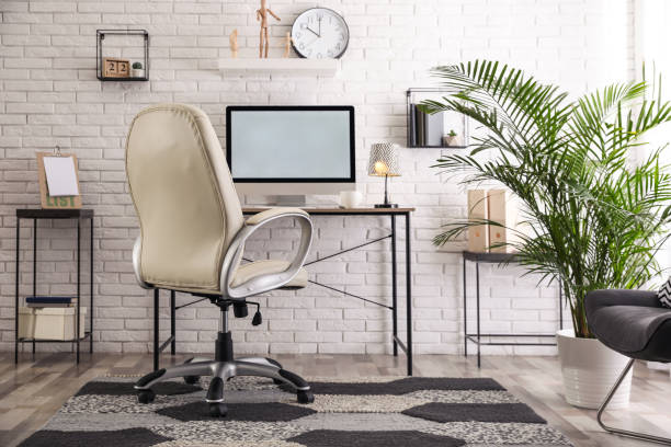 istock Comfortable chair near desk in modern office interior 1374982723