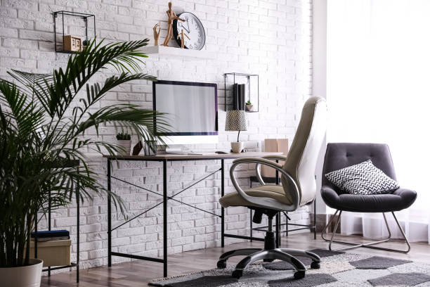 istock Comfortable chair near desk in modern office interior 1374990130