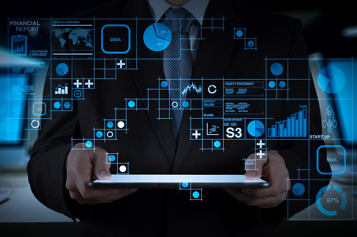 Financial report data of business operations (balance sheet and income statement and diagram) as Fintech concept.Businessman working with new modern computer