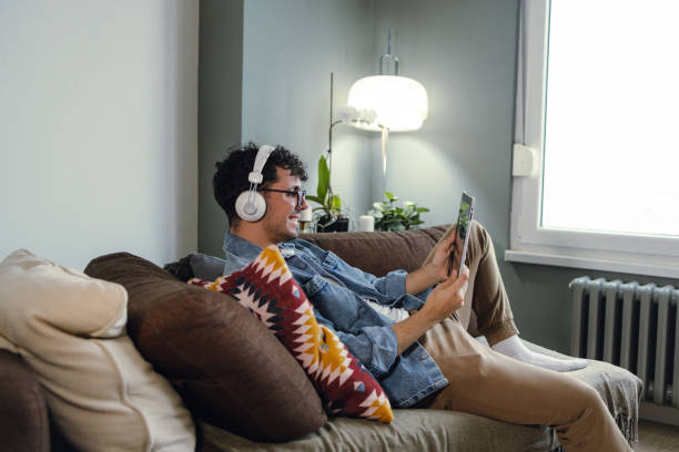 istock Young man enjoying reading internet content on a digital tablet 1374996390
