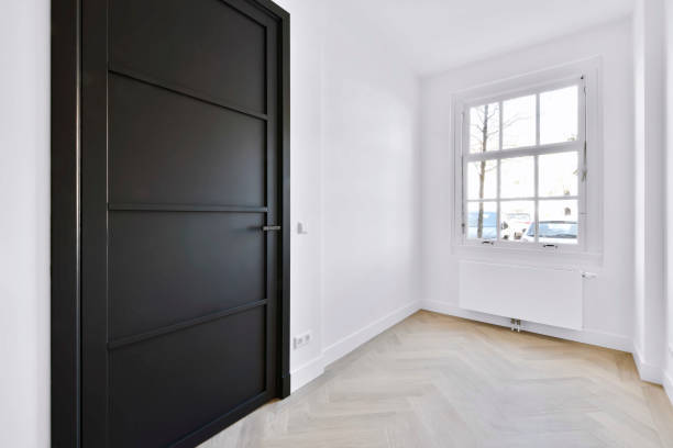 istock Stylish room in daylight with black door 1374996971