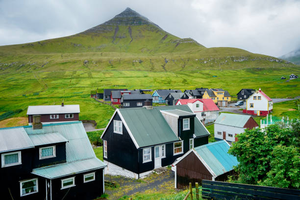 Picturesque view on village of Gjogv with typically colourful houses on the Eysturoy island, Faroe Islands, Denmark. Picturesque view on village of Gjogv with typically colourful houses on the Eysturoy island, Faroe Islands, Denmark. eysturoy stock pictures, royalty-free photos & images