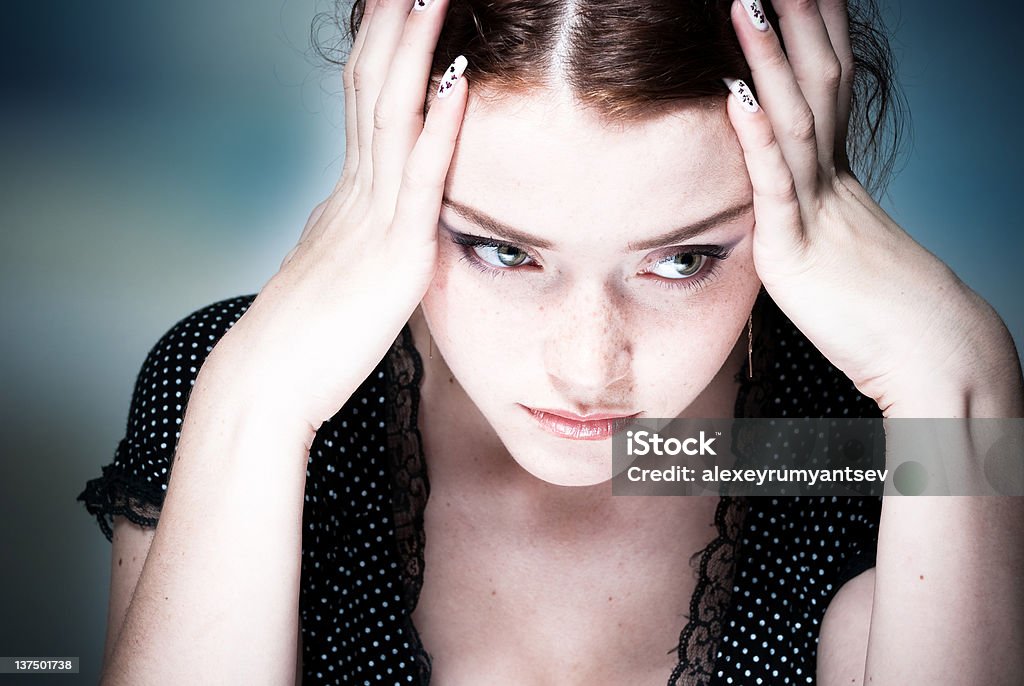 Young lady concentrating with her head in her hands young woman holding head with hands Adult Stock Photo