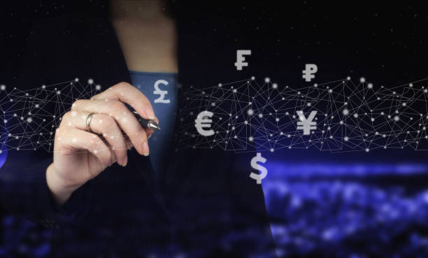 istock Global currency exchange concept Hand holding digital graphic pen and drawing digital hologram virtual currency, financial sign on city dark blurred background. Virtual currency, blockchain concept 1375020701