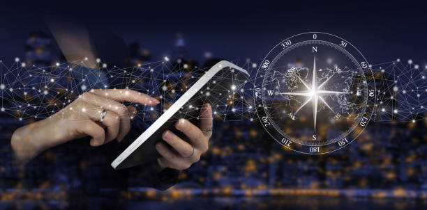 istock Global technologies concept. Hand touch white tablet with digital hologram compass sign on city dark blurred background. Abstract world network connection, internet and global connection concept. 1375020702